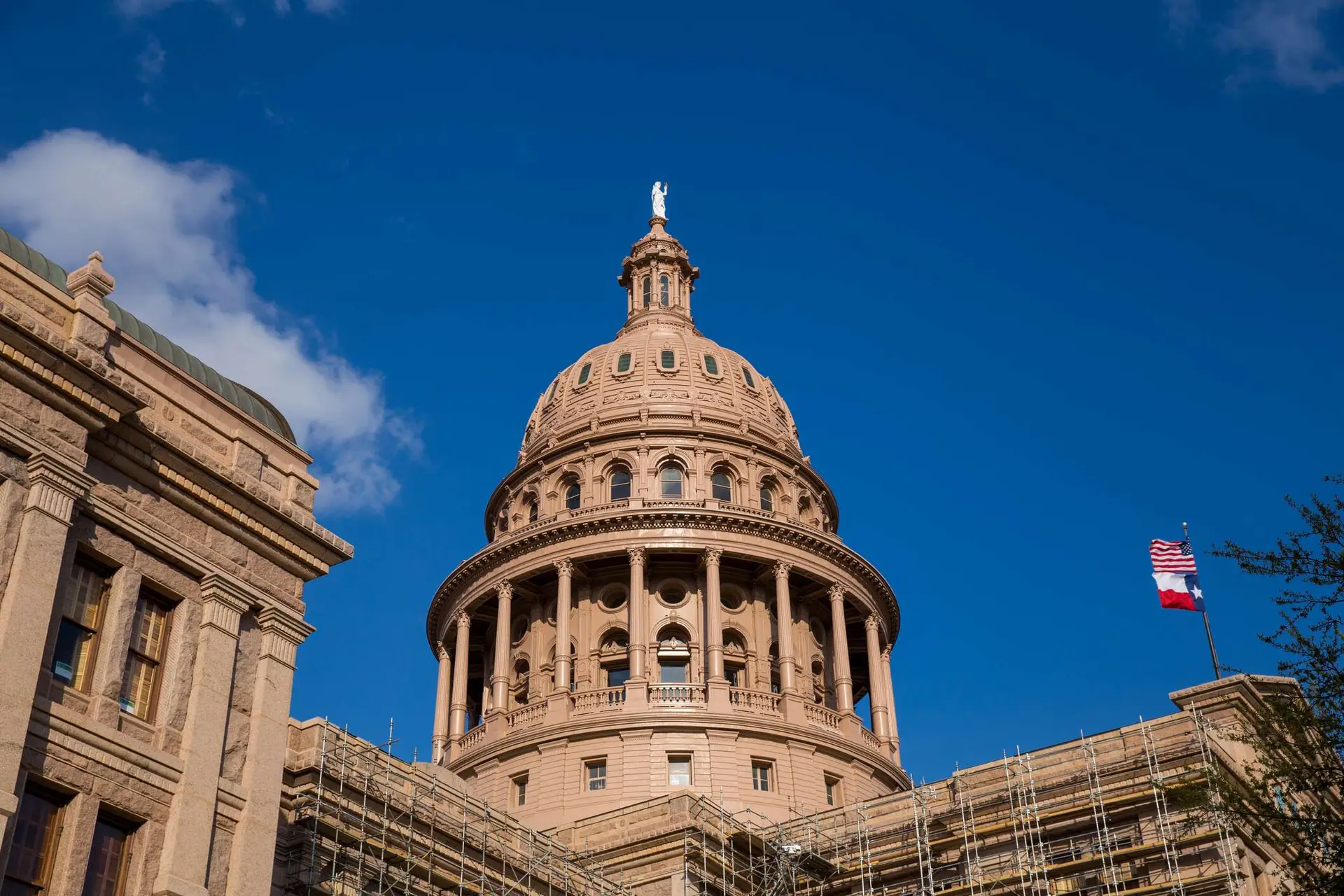 1683908317 dreamstime m 68072654 Texas Capital Building w waving Flags Image