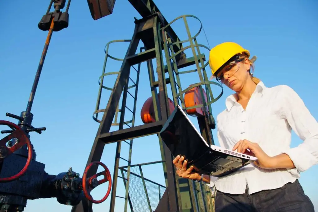 dreamstime m 26898353 Businesswoman with a notebook in an oilfield Image